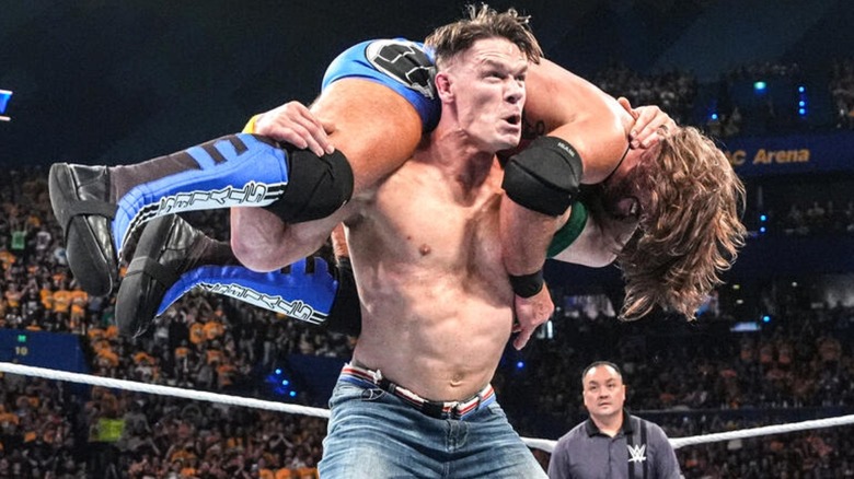 John Cena hits AJ Styles with the Attitude Adjustment