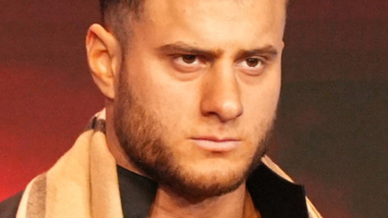 MJF scowling in a scarf
