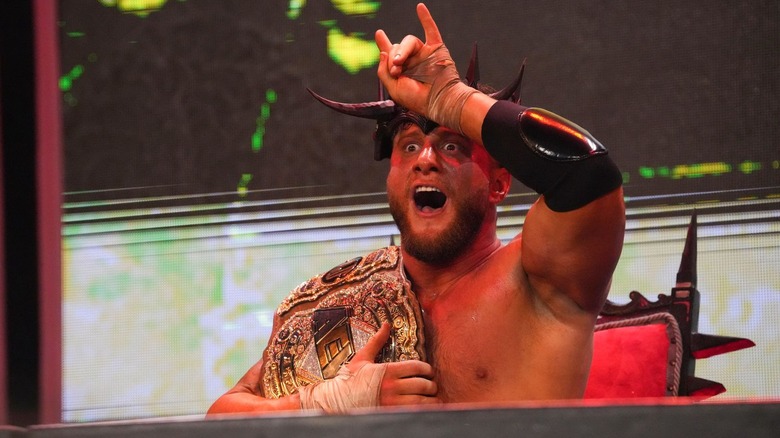 MJF makes devil horns while lowering into Hell