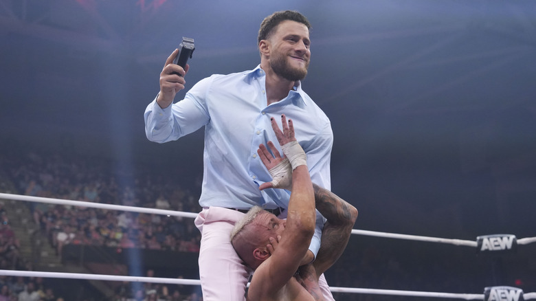 MJF looks to cut AEW World Champion Darby Allin with a pair of hair clippers in the middle of the ring during an episode of 