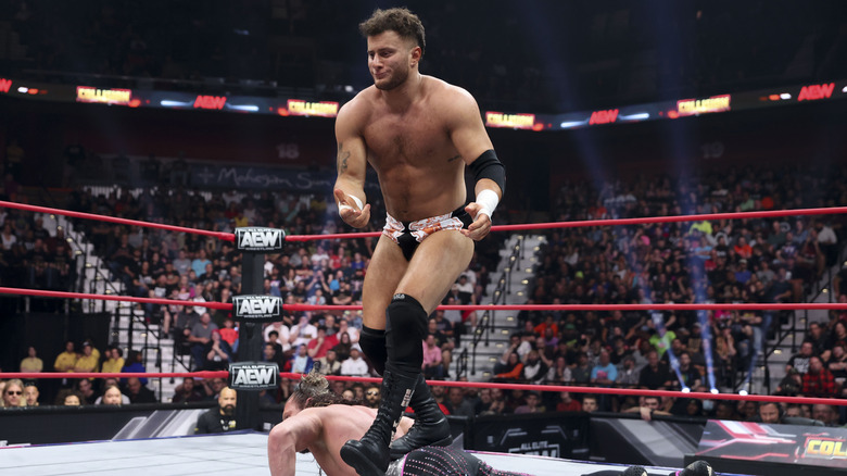 MJF struts on Kenny Omega's back