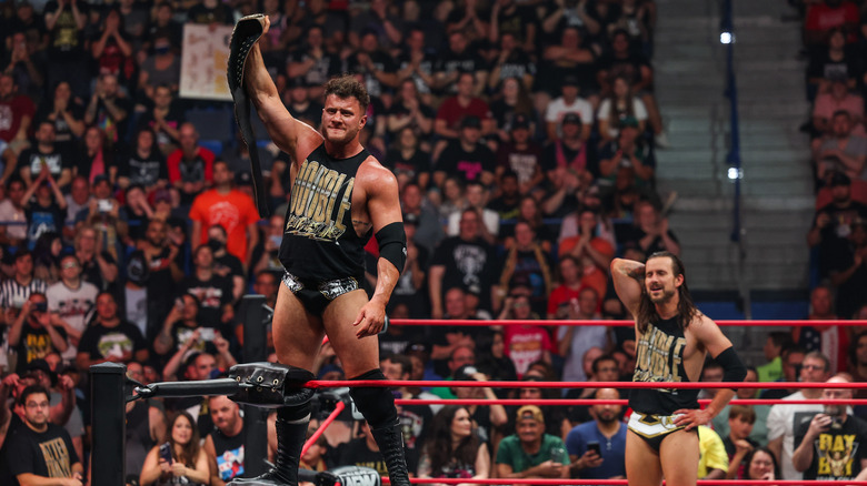 MJF celebrates with his title while Cole looks on