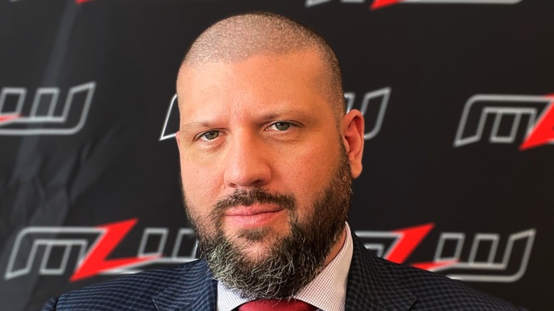 Court Bauer standing in front of an MLW logo