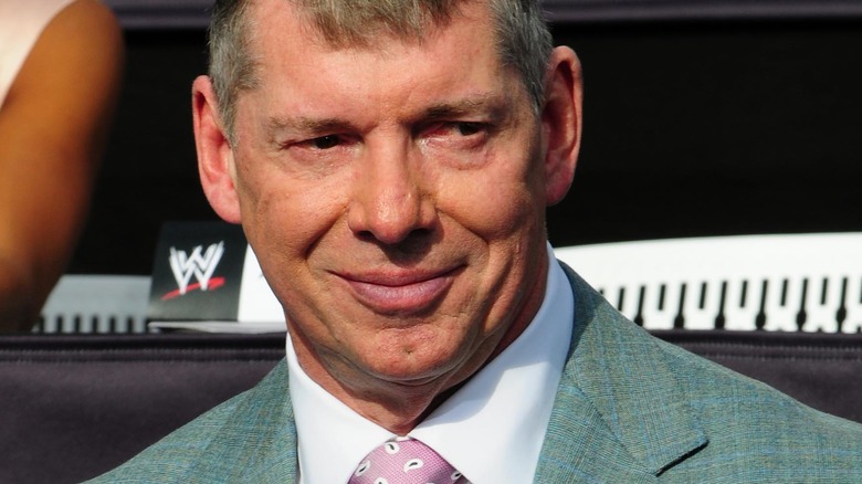 Vince McMahon sitting at a press conference
