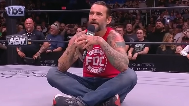 CM Punk sits corss legged