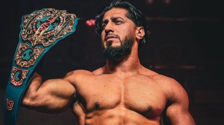 Mustafa Ali proudly holds up his TNA International Championship