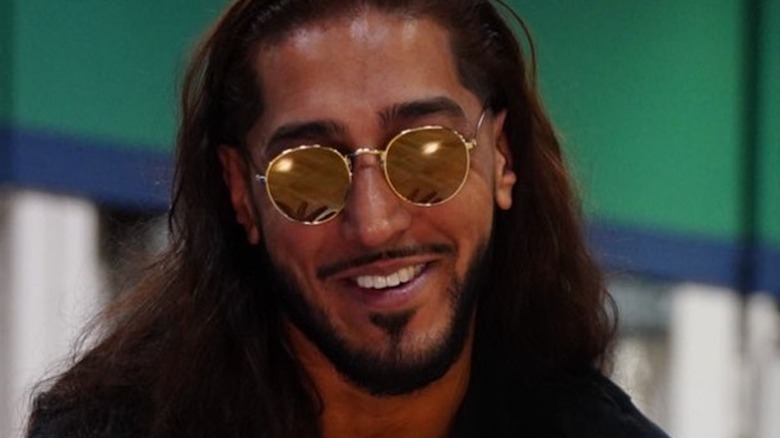 Mustafa Ali smiling with some glasses on