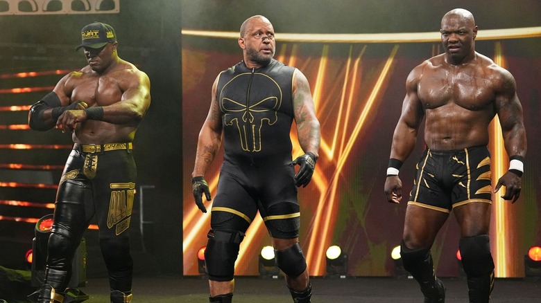 Bobby Lashley, MVP, and Shelton Benjamin standing on a stage