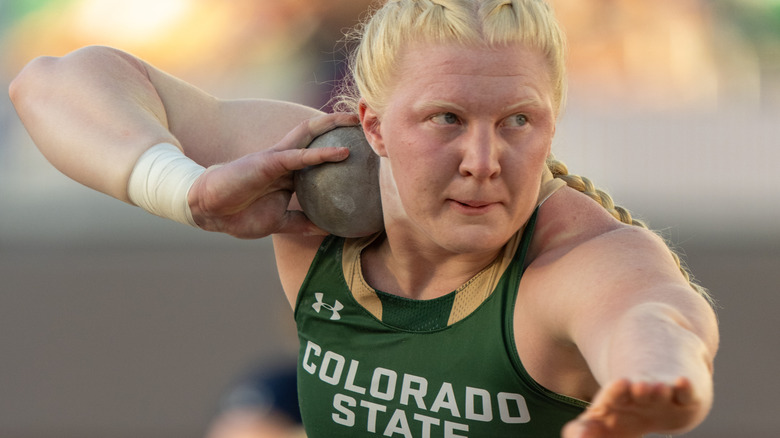 Mya Lesnar preparing to shot put with a Colorado State University shirt on