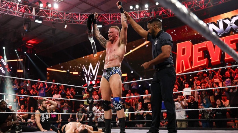 A referee holds up the arm of Myles Borne after a successful defense of his North American Championship on an episode of 