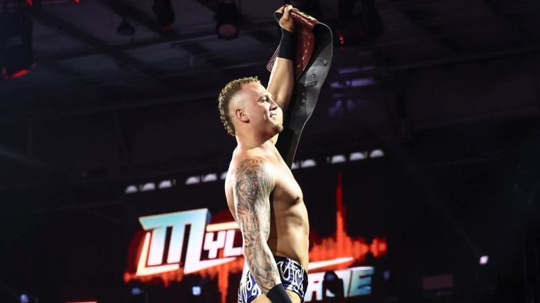 North American Champion Myles Borne stands on the ropes and poses with the title on an episode of 