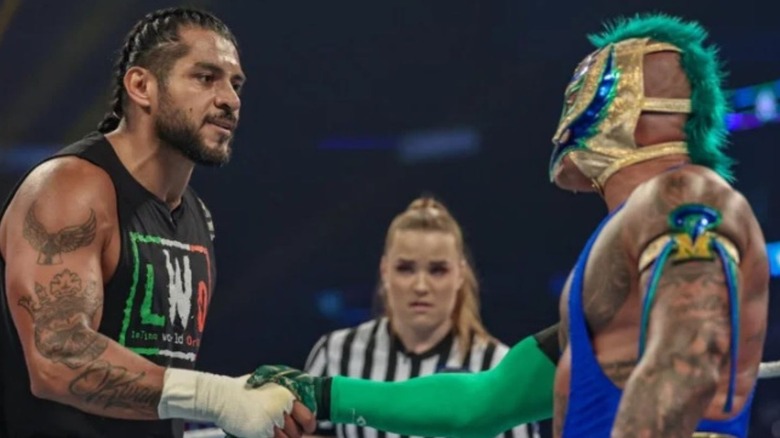 Santos Escobar and Rey Mysterio shake hands in the middle of the ring on an episode of 'WWE SmackDown."
