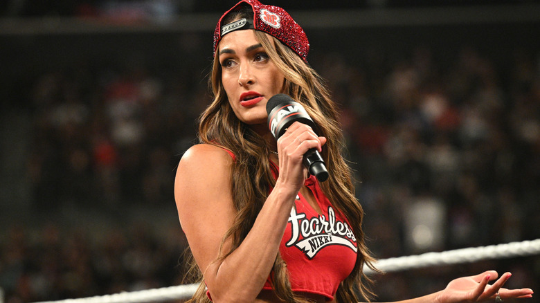 Nikki Bella holding a microphone