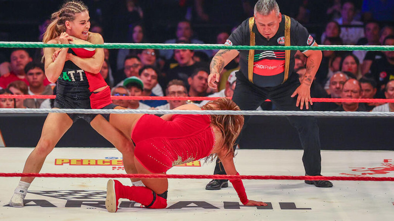 Natalya puts Flammer in an ankle lock in AAA