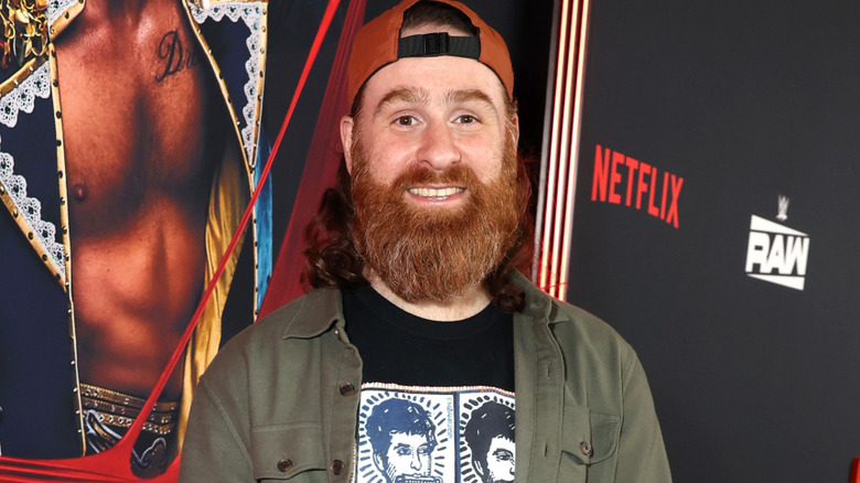 Sami Zayn wearing a backwards hat