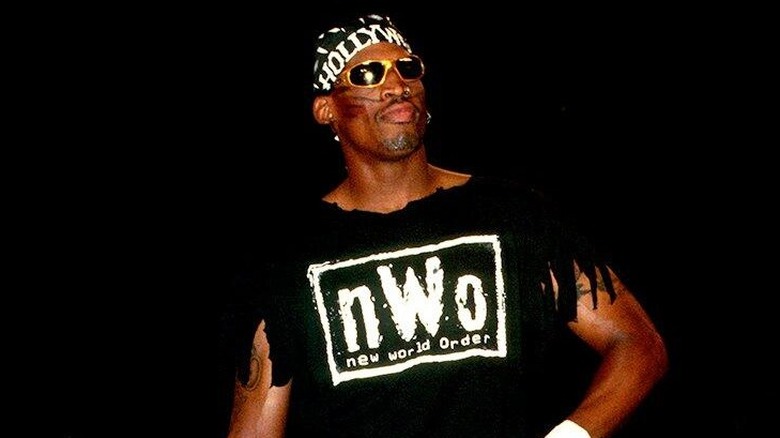 Dennis Rodman poses in the ring with a signature nWo shirt