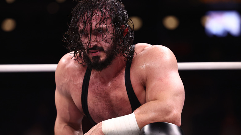PAC kneels in the ring, awaiting his challenger, before a match on the September 23, 2026 edition of 
