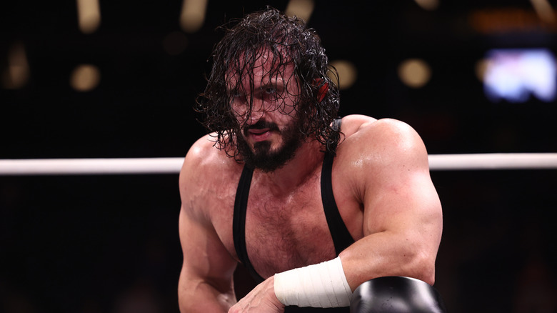 PAC kneels in the ring, awaiting his challenger, before a match on the September 23, 2026 edition of 