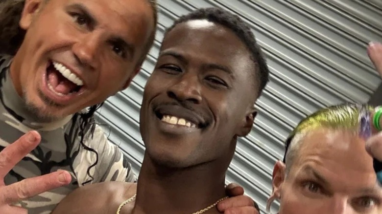 YouTuber streamer BDE poses backstage for a selfie with Matt and Jeff Hardy.