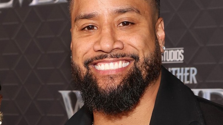 Jey Uso smiling at a press event 