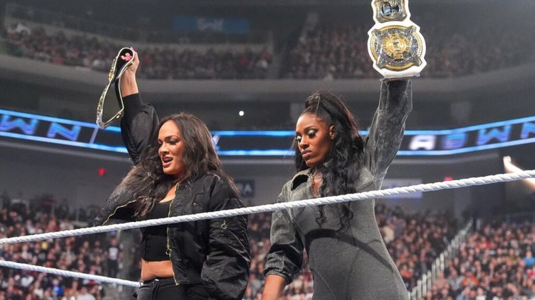 Nia Jax and Lash Legend hold up the WWE Women's Tag Team Championships in the ring on 