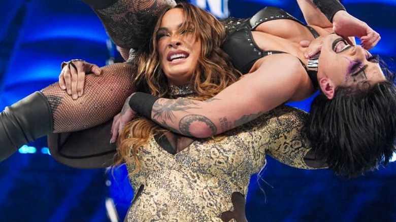 Nia Jax holding Rhea Ripley on her shoulders 