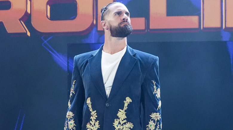 Seth Rollins wearing a navy blue long coat