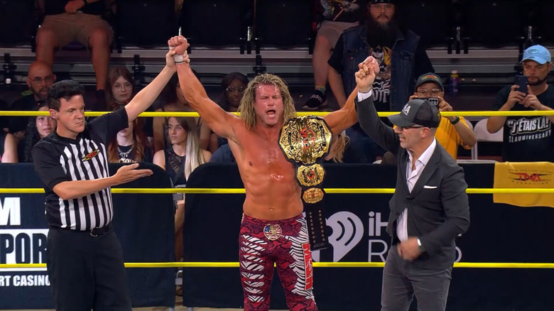 Nic Nemeth celebrates with the TNA World Championship alongside Carlos Silva
