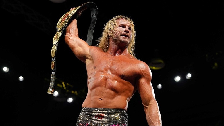 Nic Nemeth holding the TNA World Championship above his head after winning the title.