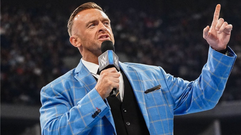 Nick Aldis talking into a microphone