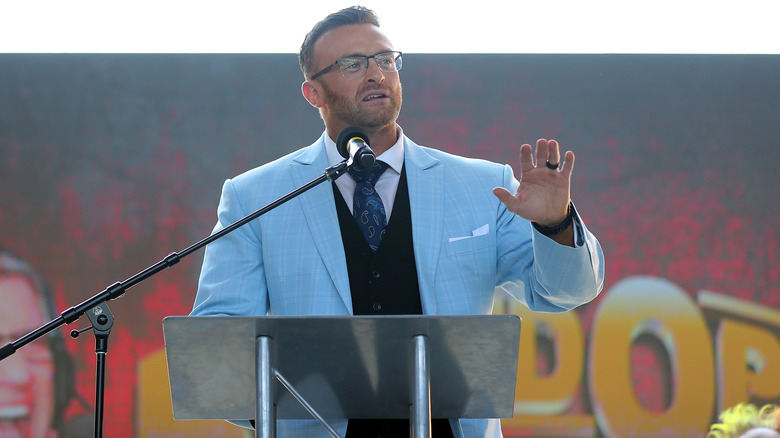 Nick Aldis speaks at the podium