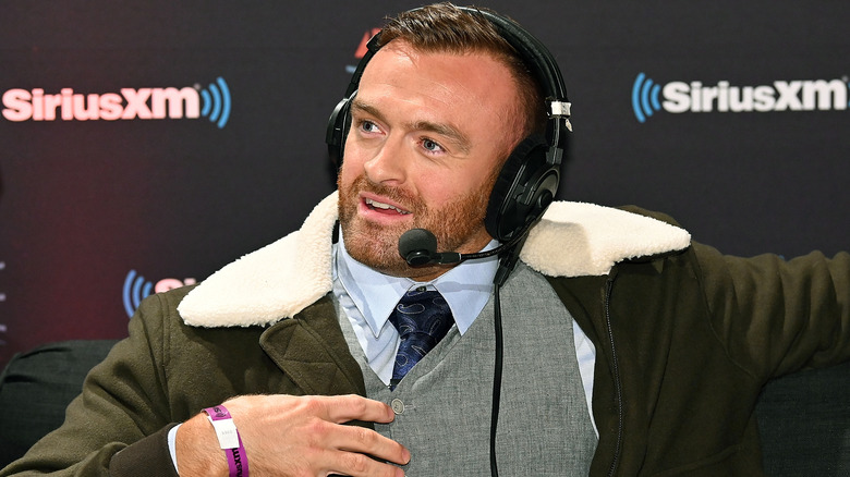 Nick Aldis sits with a headset on