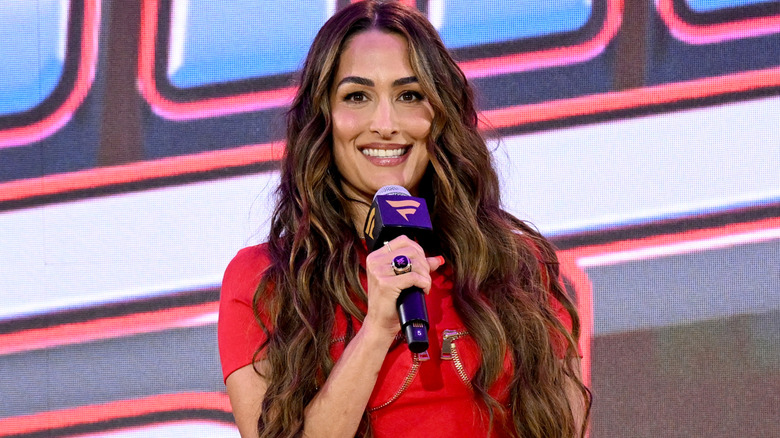 Nikki Bella holding a microphone