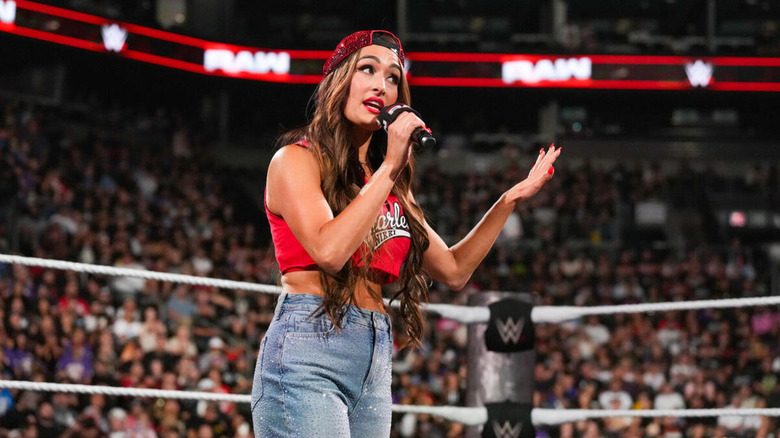 Nikki Bella speaks on the microphone on an episode of 