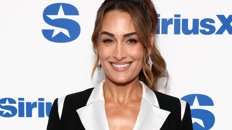 Nikki Bella is smiling.