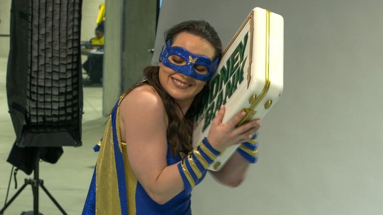 Nikki Cross showing off the Women's Money in the Bank briefcase after winning it during her 
