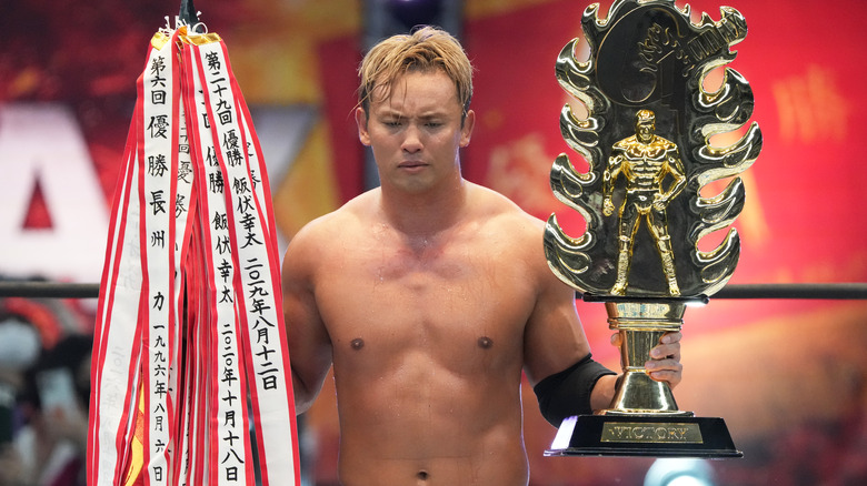 Kazuchika Okada celebrating his NJPW G1 Climax 32 victory inside the ring