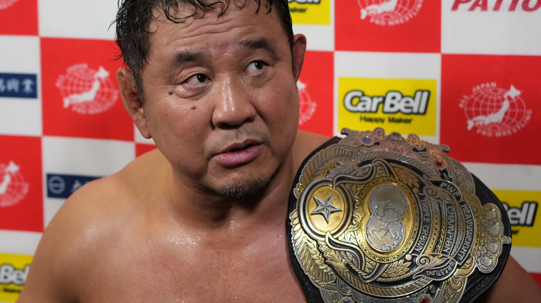 Yuji Nagata holding the 2013 version of the AJPW Triple Crown Championship
