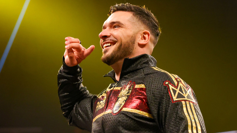 Ethan Page smiling and posing in the ring