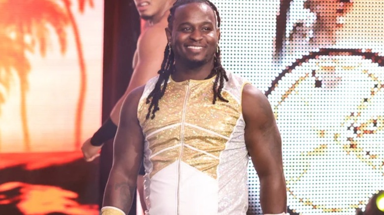 Scrypts stands smiling on the stage of "WWE NXT" before a match.