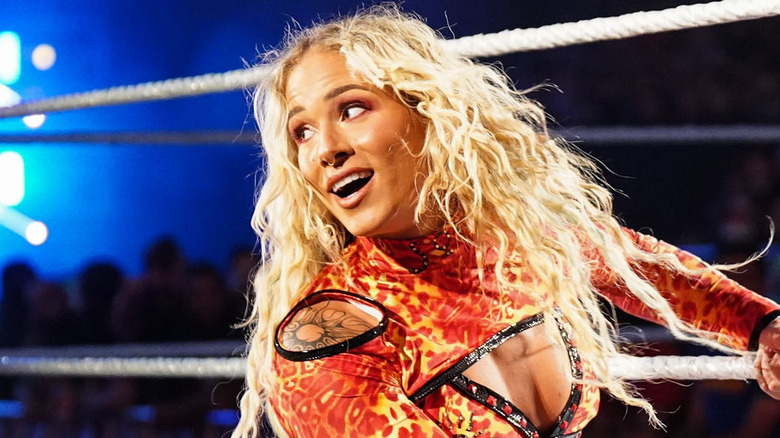 Kelani Jordan posing between the ropes of a WWE ring