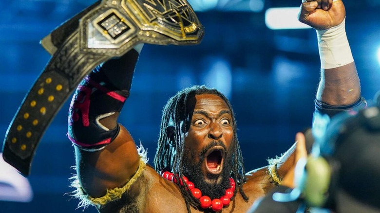 Oba Femi poses for a WWE camera and holds up the NXT Championship ahead of a match on 
