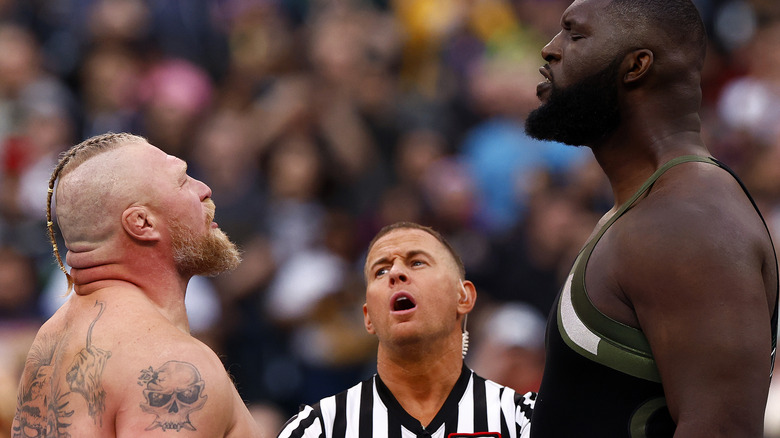 Brock Lesnar and Omos having a staredown