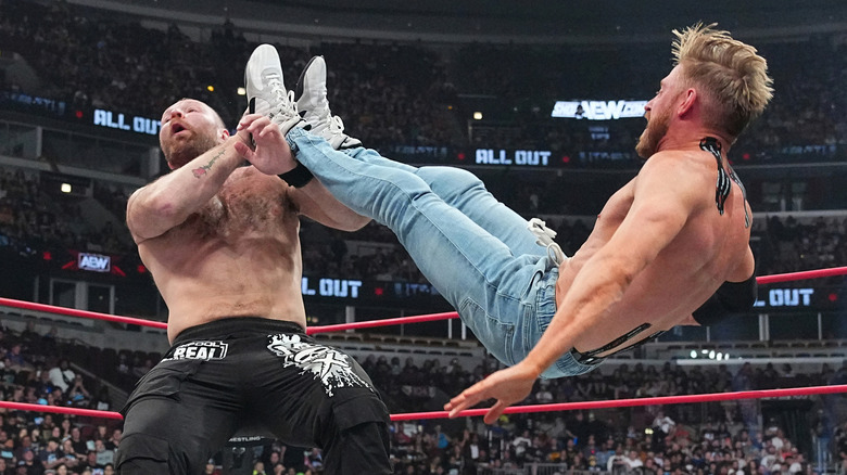 Orange Cassidy kicking Jon Moxley