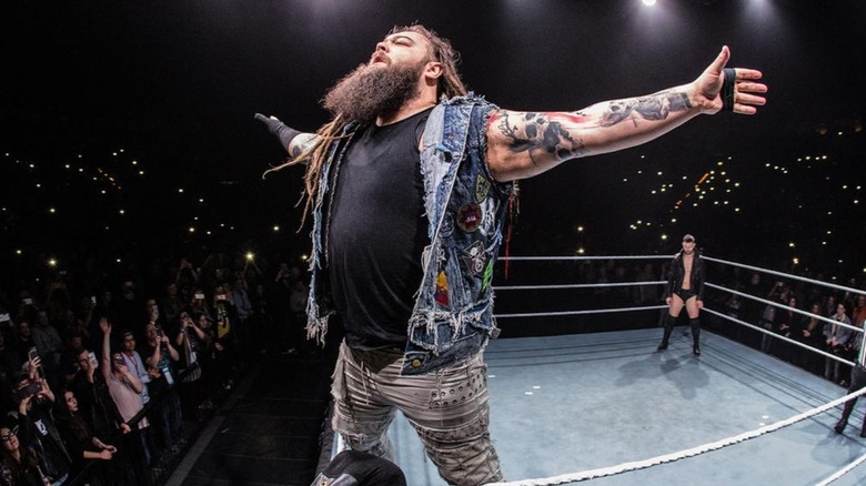 Late WWE superstar Bray Wyatt stands on the turnbuckle and poses in the ring during a WWE event in Germany.