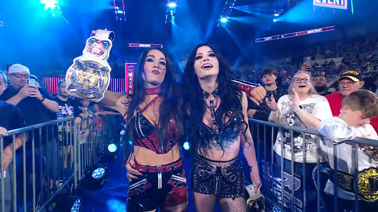 Paige and Brie Bella celebrate with the Tag titles