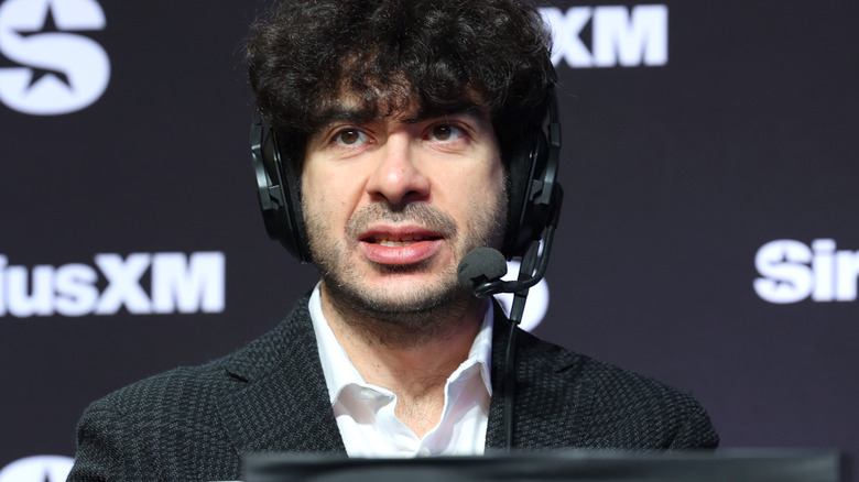 Tony Khan speaking on a headset