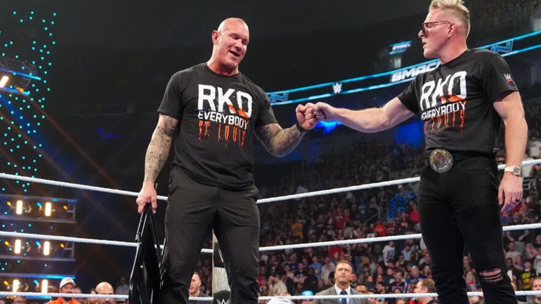 Pat McAfee and Randy Orton bump fists in the ring after taking out Undisputed WWE Champion Cody Rhodes on 