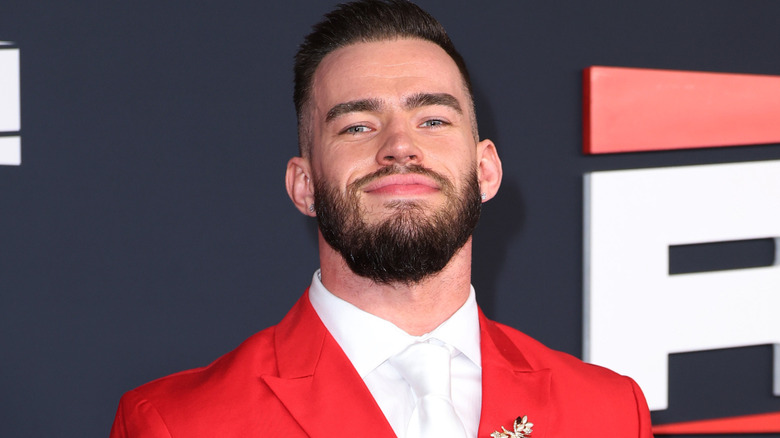 Austin Theory wearing a red blazer