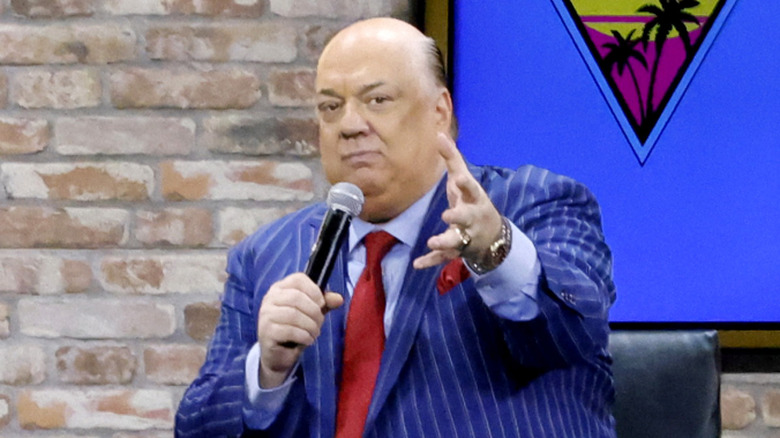 Paul Heyman reaches out his hand